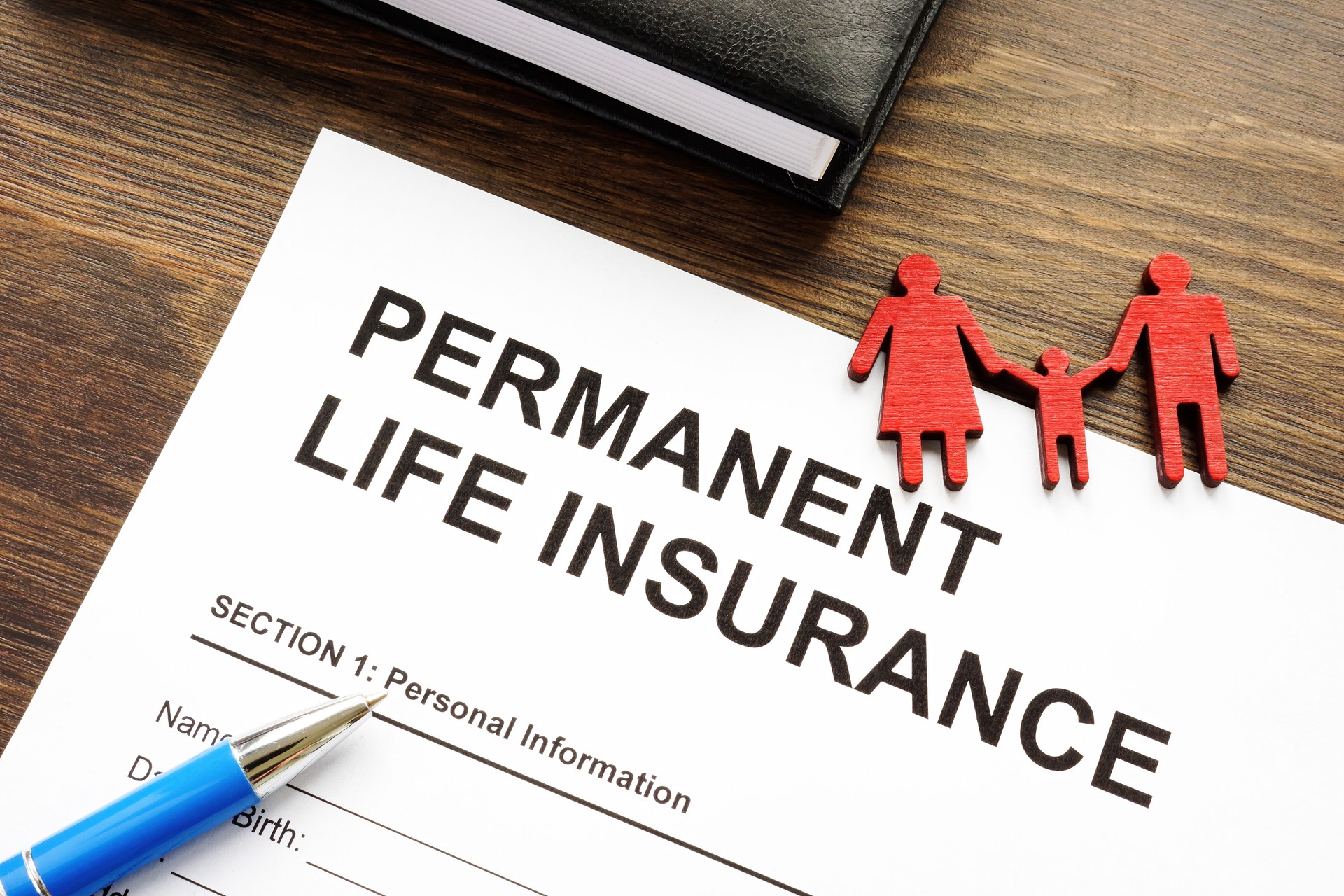 Permanent life insurance application and family figurine.