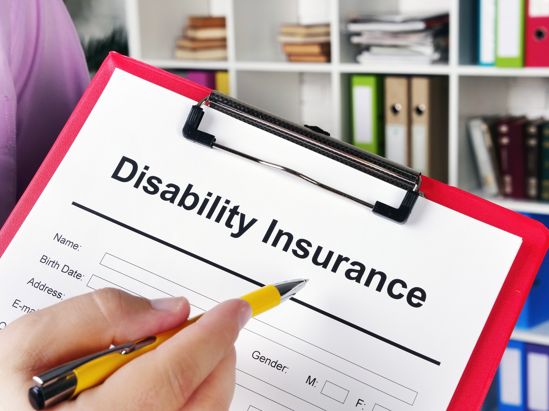 Insurer shows Disability insurance application for signing.